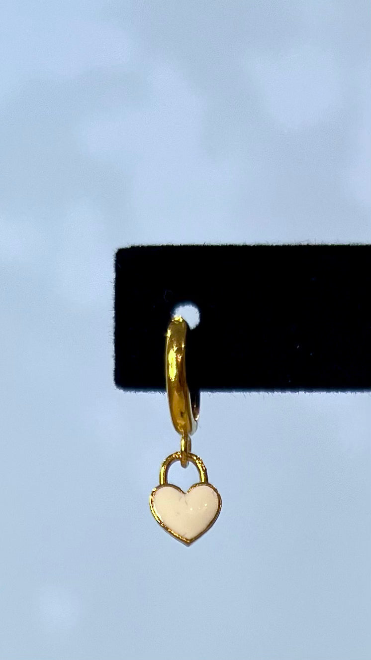 Gold hoops with white dangly hearts