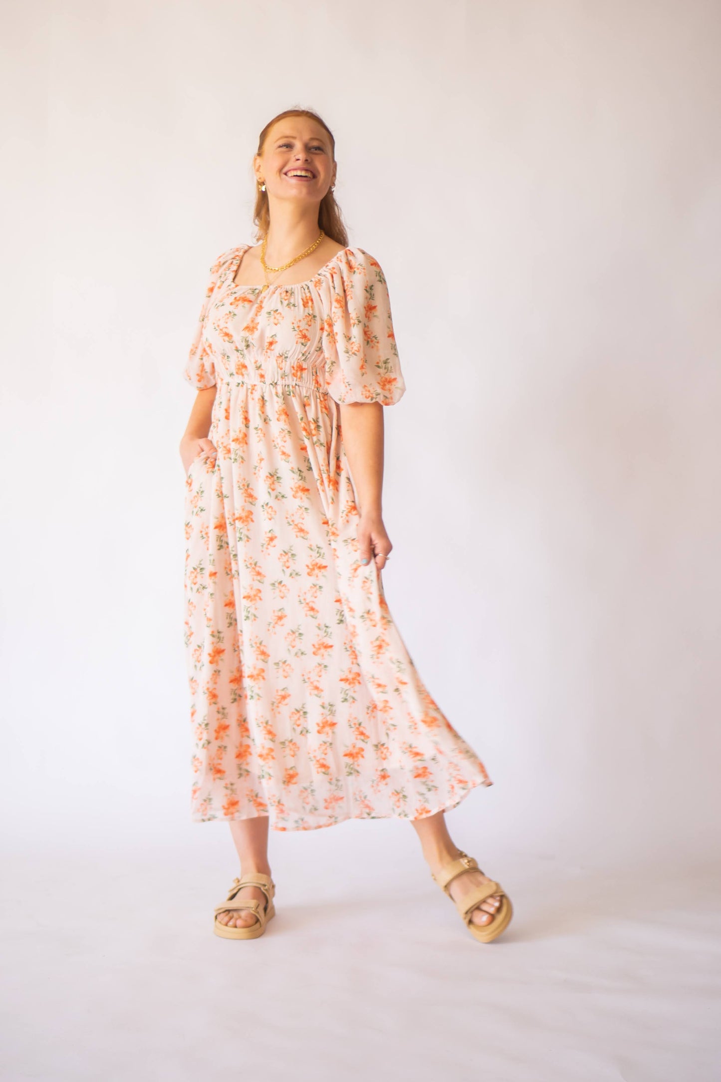 Pink floral maxi dress with puff sleeves and cinched waist