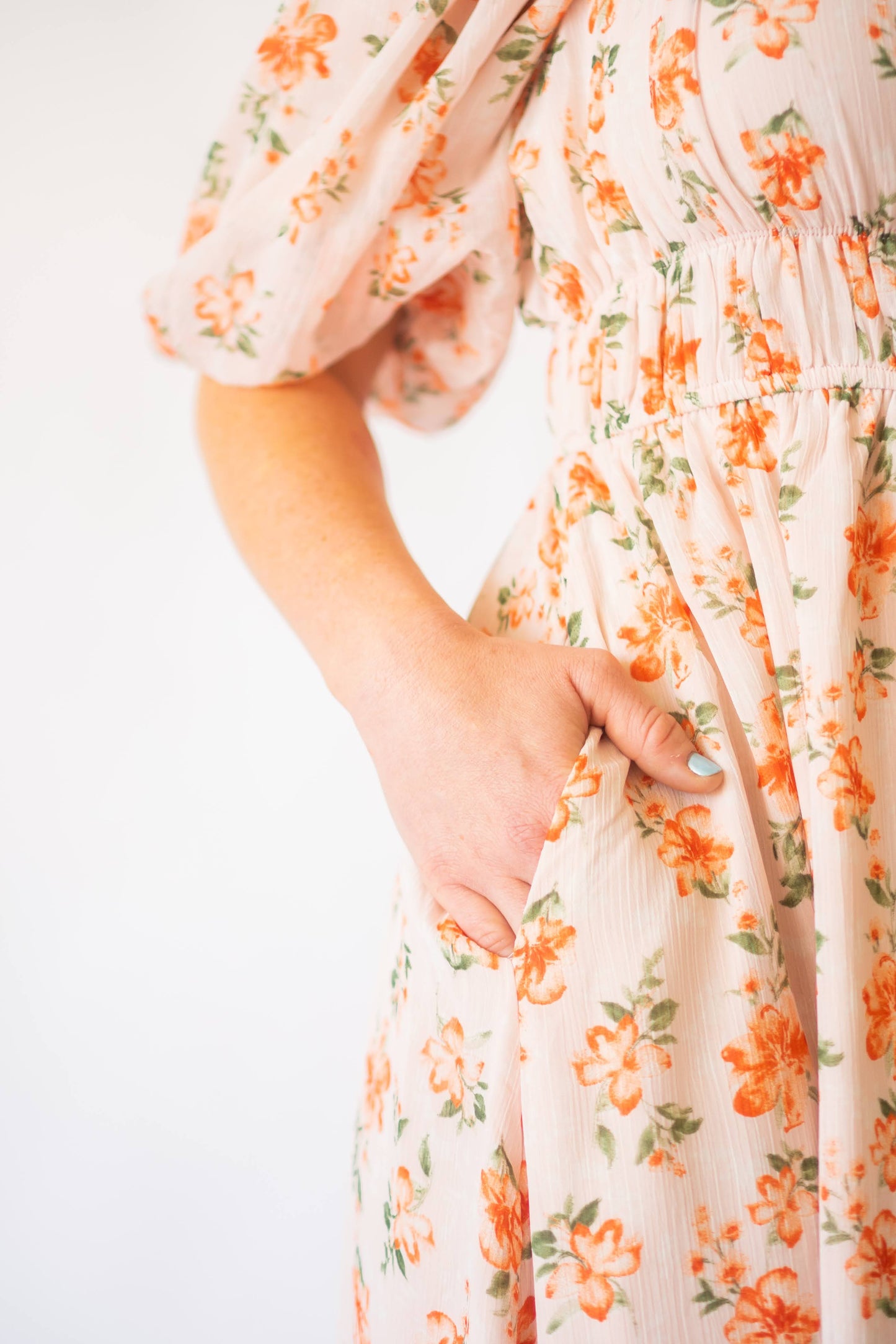 Pink and orange floral dress with cinched waist and pockets