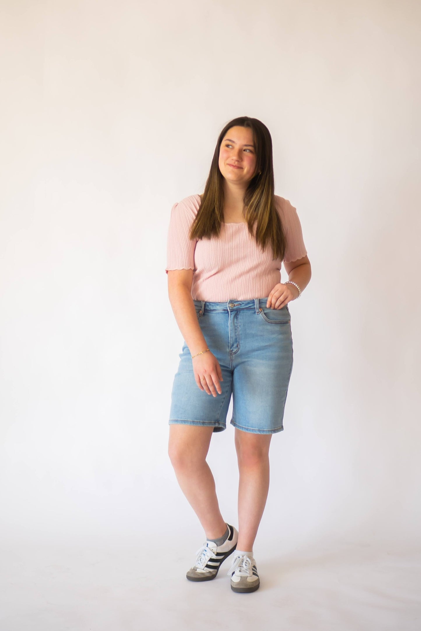 Light wash knee length denim shorts.