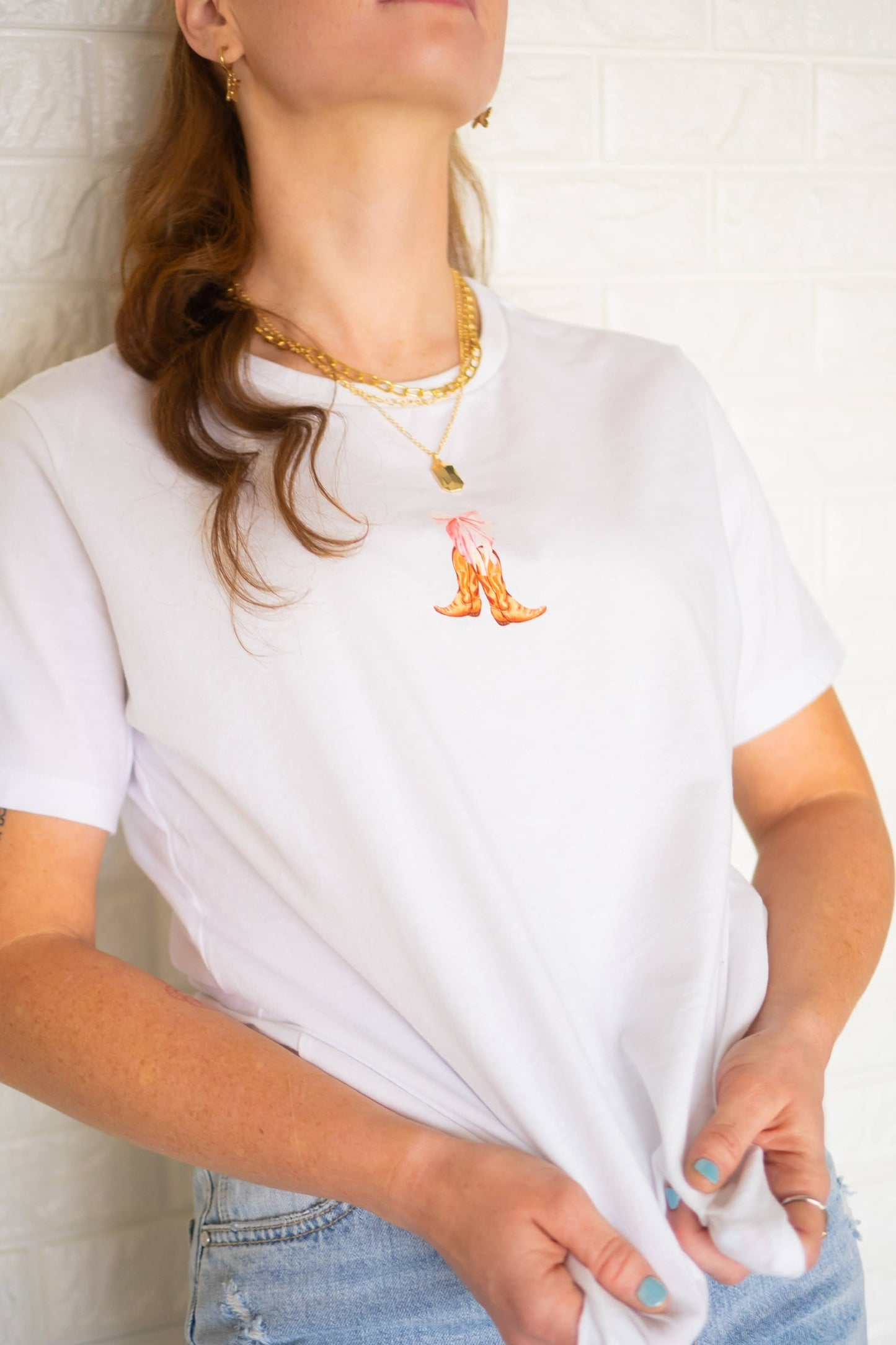 White tee with cowboy boots and pink bow