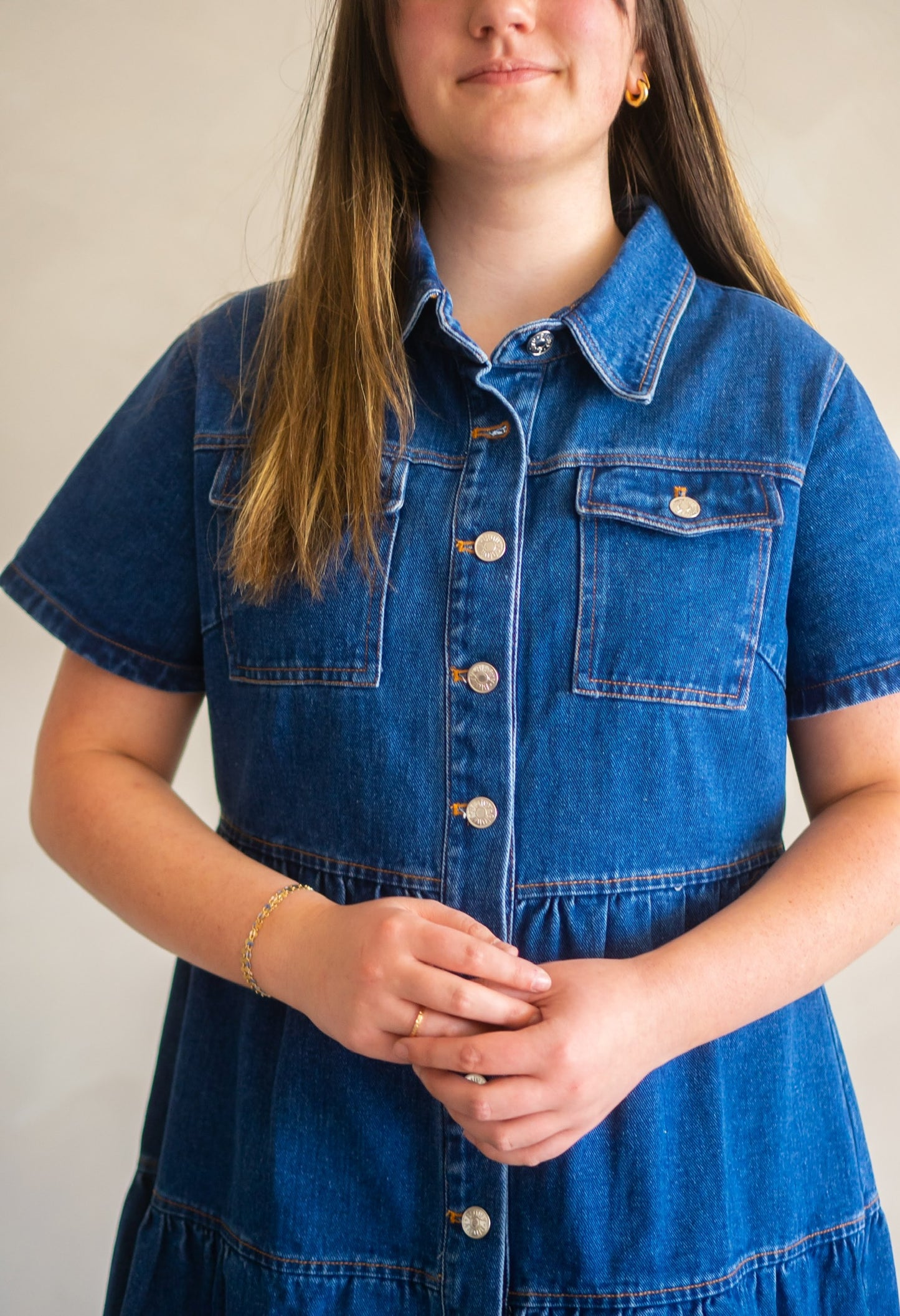 Close up of the Cassidy dress featuring double front pockets, collared neckline, and front buttons.