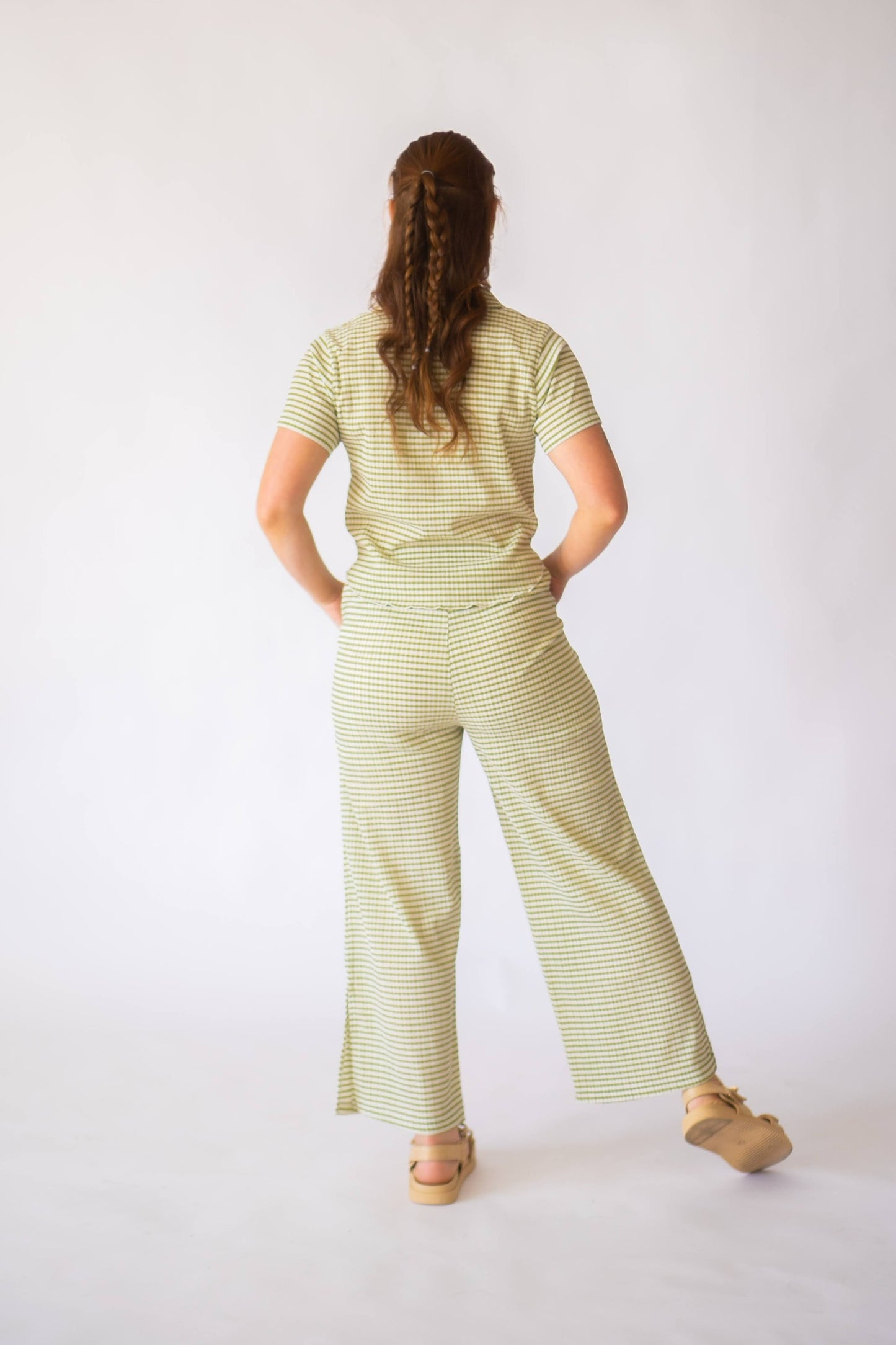 Back of green striped matching set with short sleeve top and long wide leg bottoms