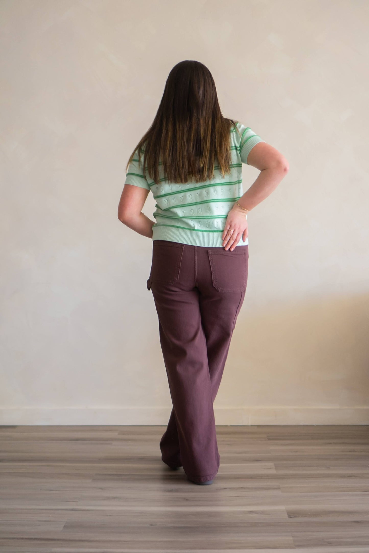 Back of green knit floral striped top.