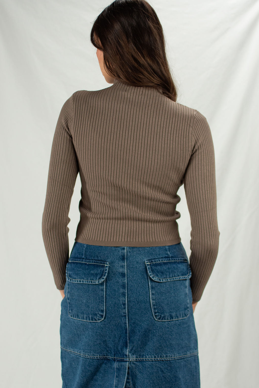Back of brown mock neck fitted sweater with cropped fit