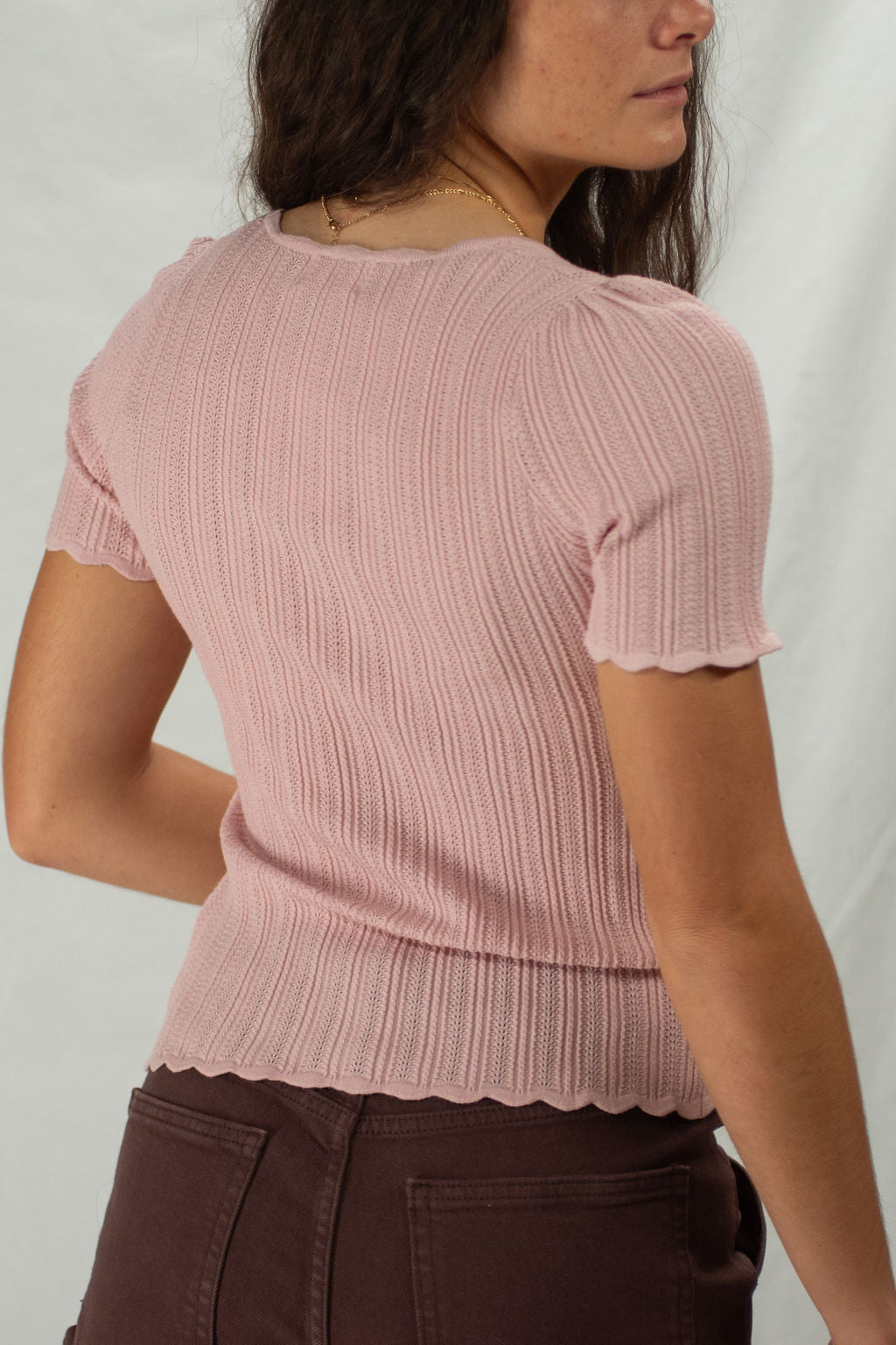 Back of pink scoop neck scalloped blouse with full coverage back