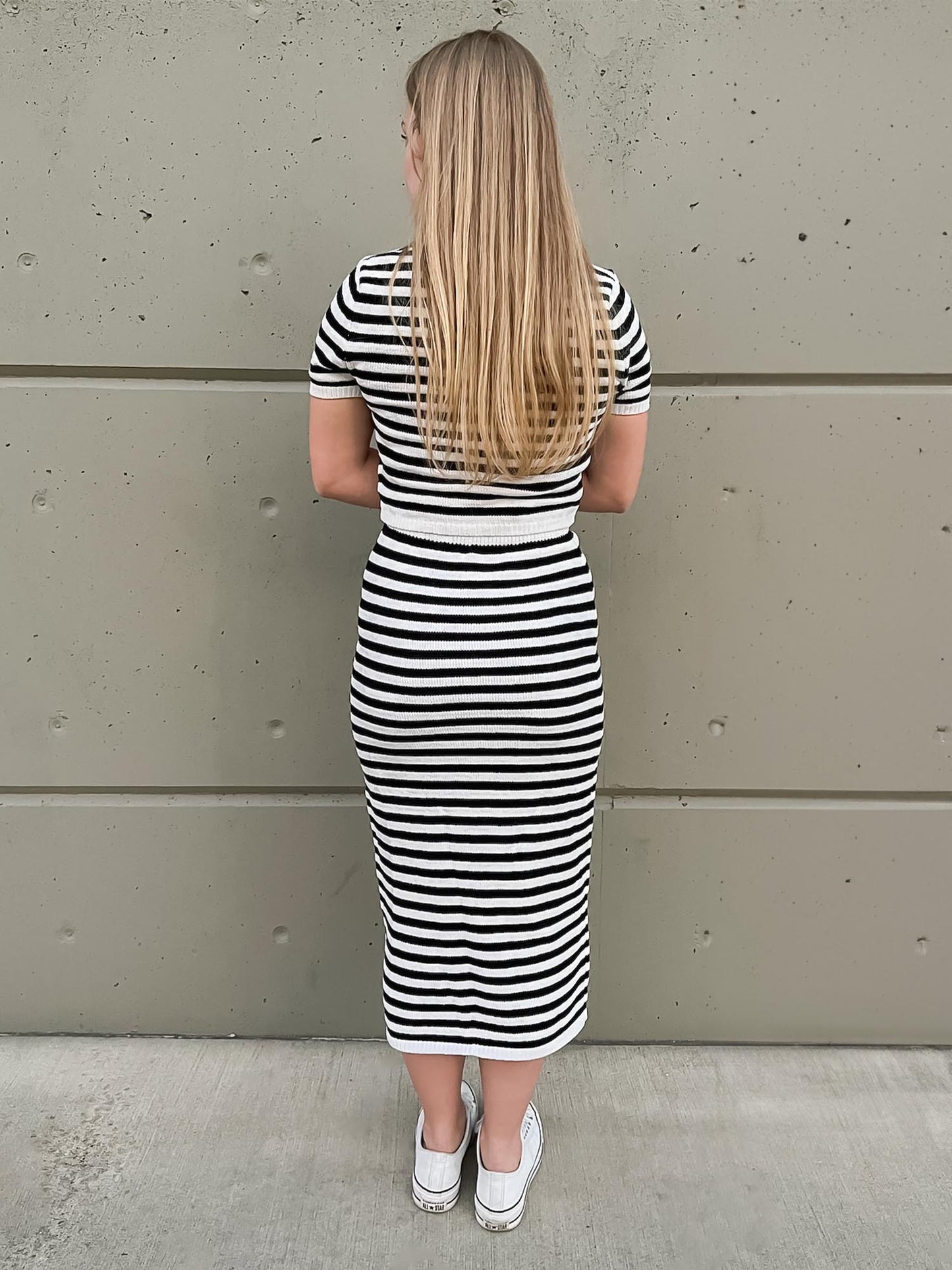 Back of two-piece short sleeve striped sweater crop top with midi skirt