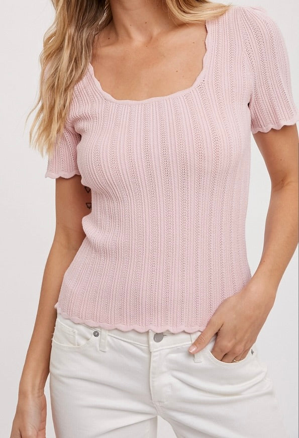 Pink scoop neck knit top with scalloped edges