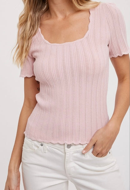 Pink scoop neck knit top with scalloped edges