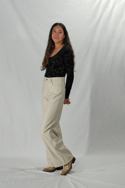 Woman wearing faux leather pants in cream