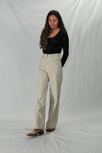 Woman wears cream wide leg leather pants with black top