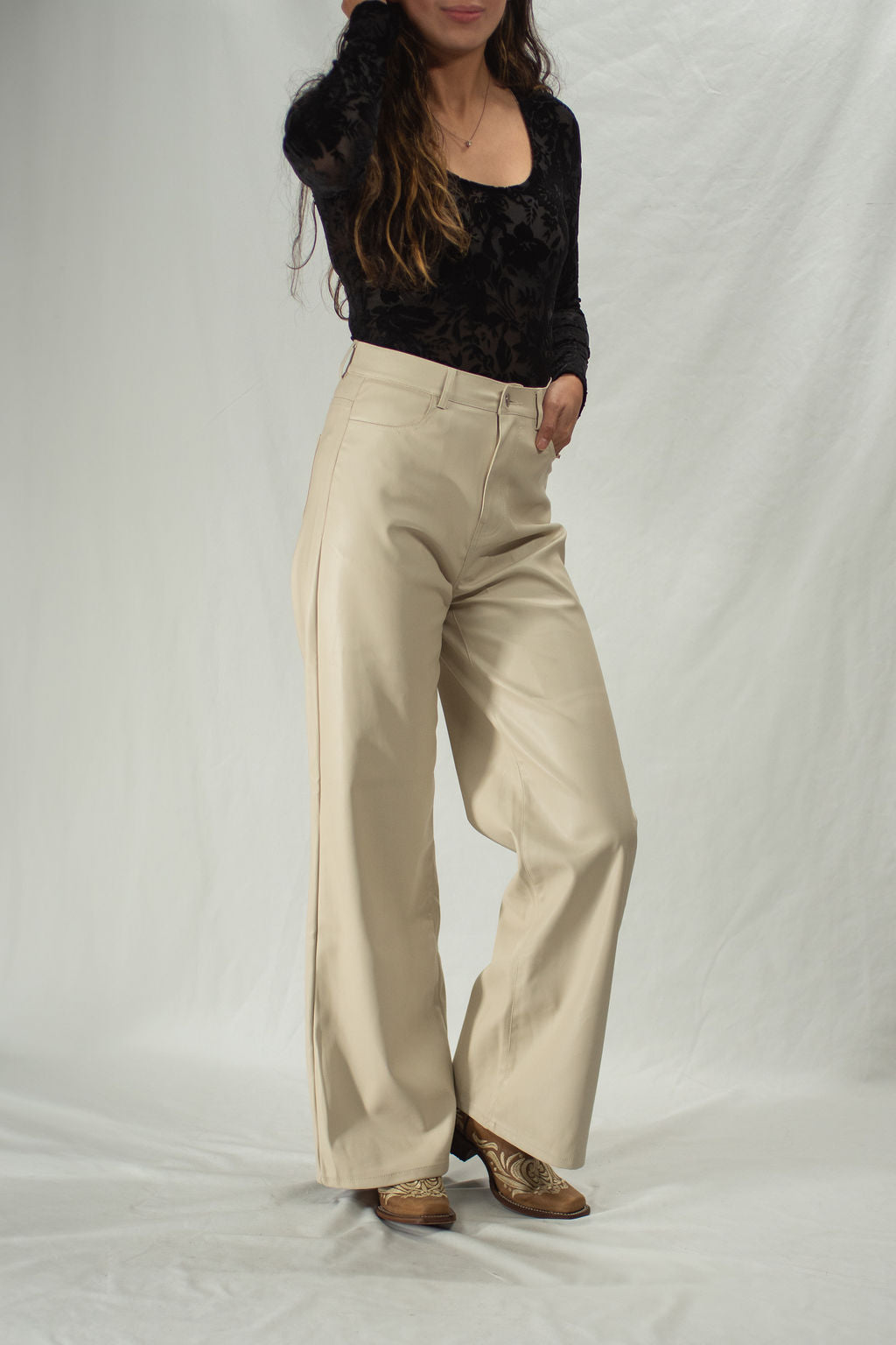 Woman wearing cream leather pants with wide leg