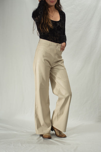 Woman wearing cream leather pants with wide leg