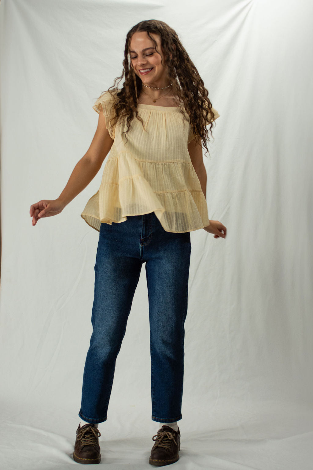 Woman wearing straight leg mom jeans in dark wash