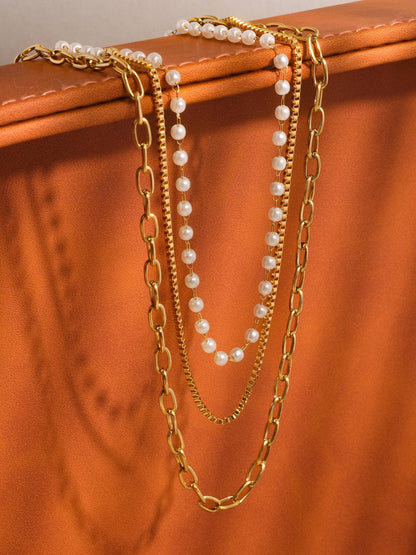 Two gold chains and a pearl beaded necklace