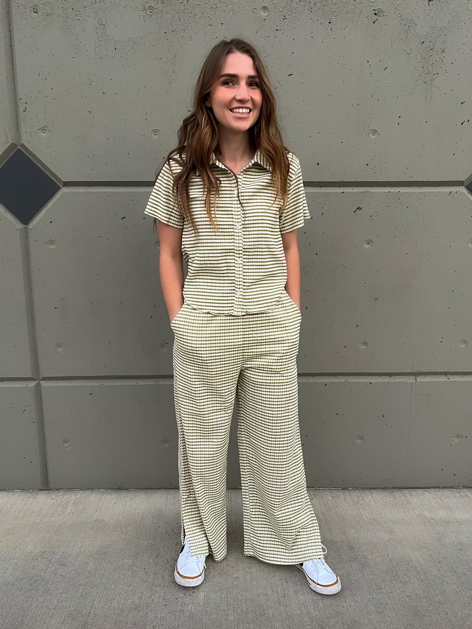 Girl wearing green striped set with button up shirt and split hem pants