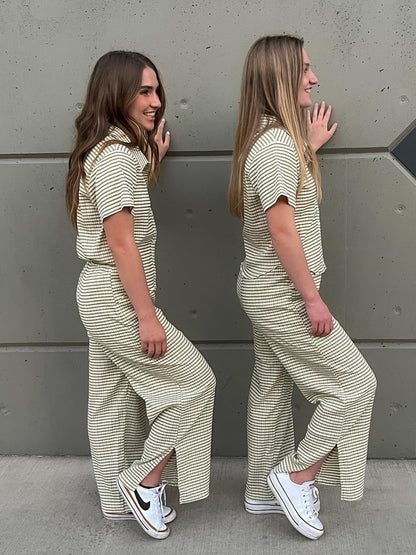 Two girls showing off the split hem of green striped wide leg lounge pants