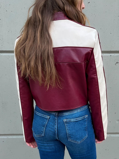 Back of cherry red cropped moto jacket with cream racker stripes