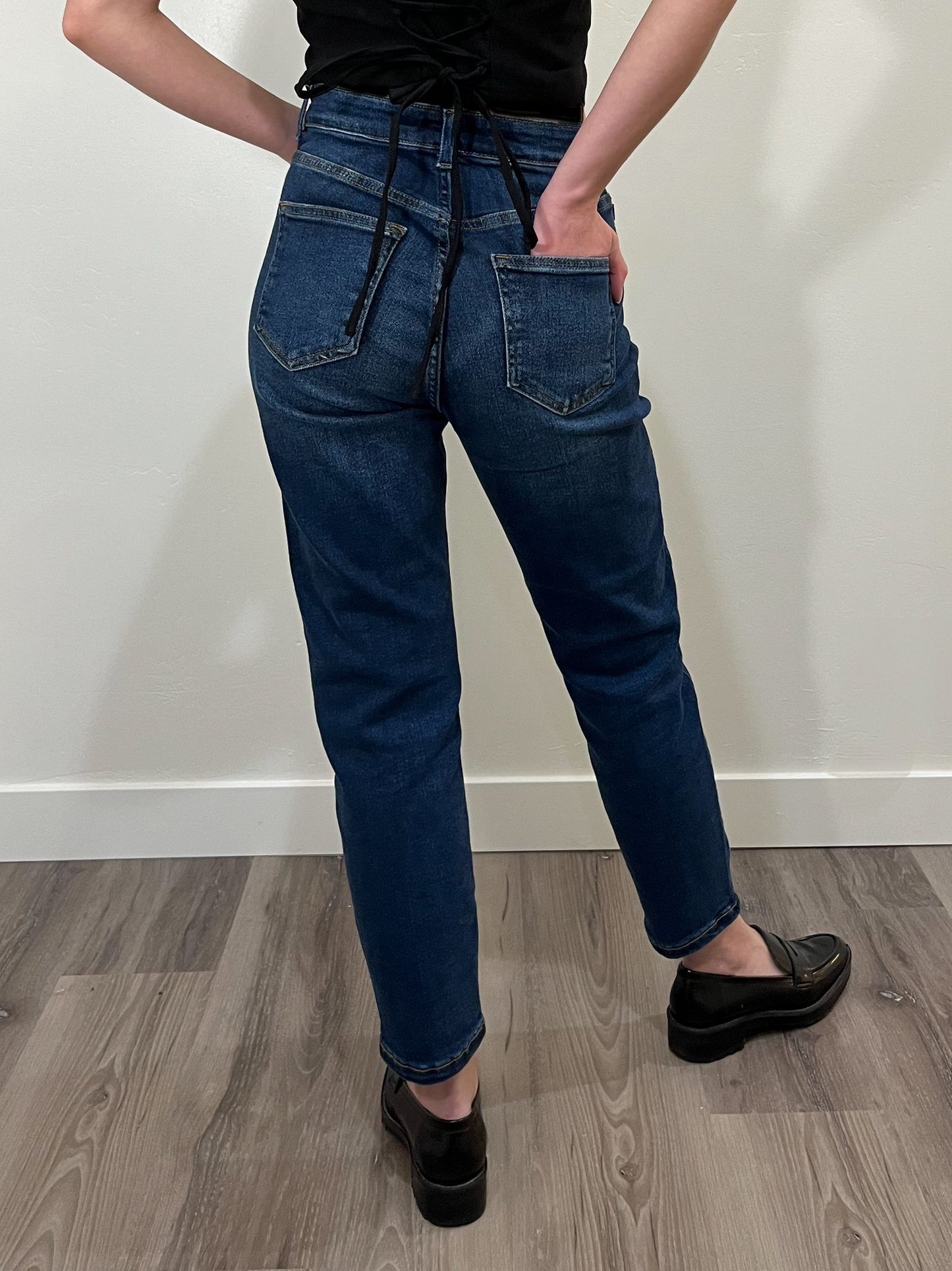 Dark wash straight-leg mom jeans, back view